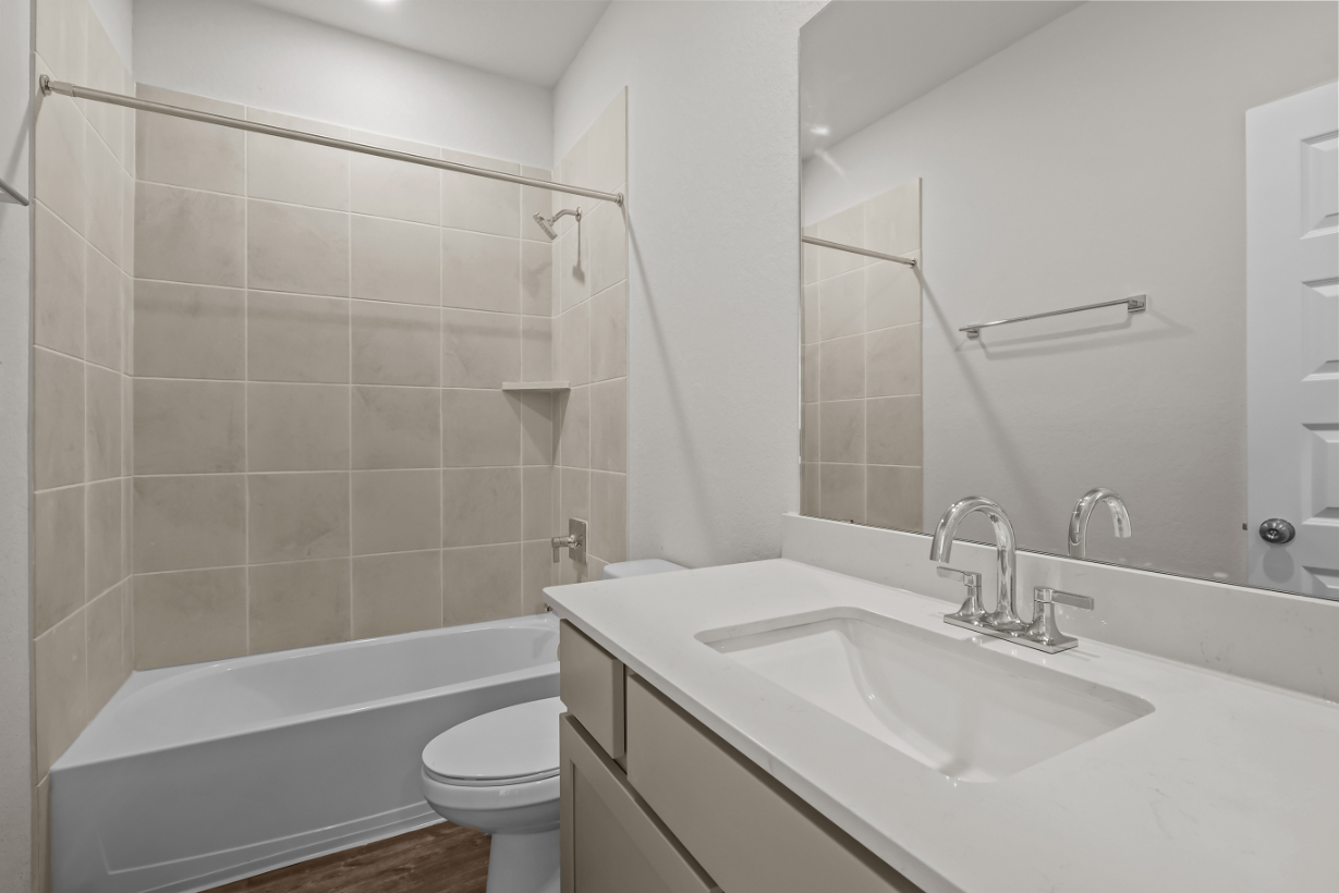 A bathroom with a sink and a toilet.