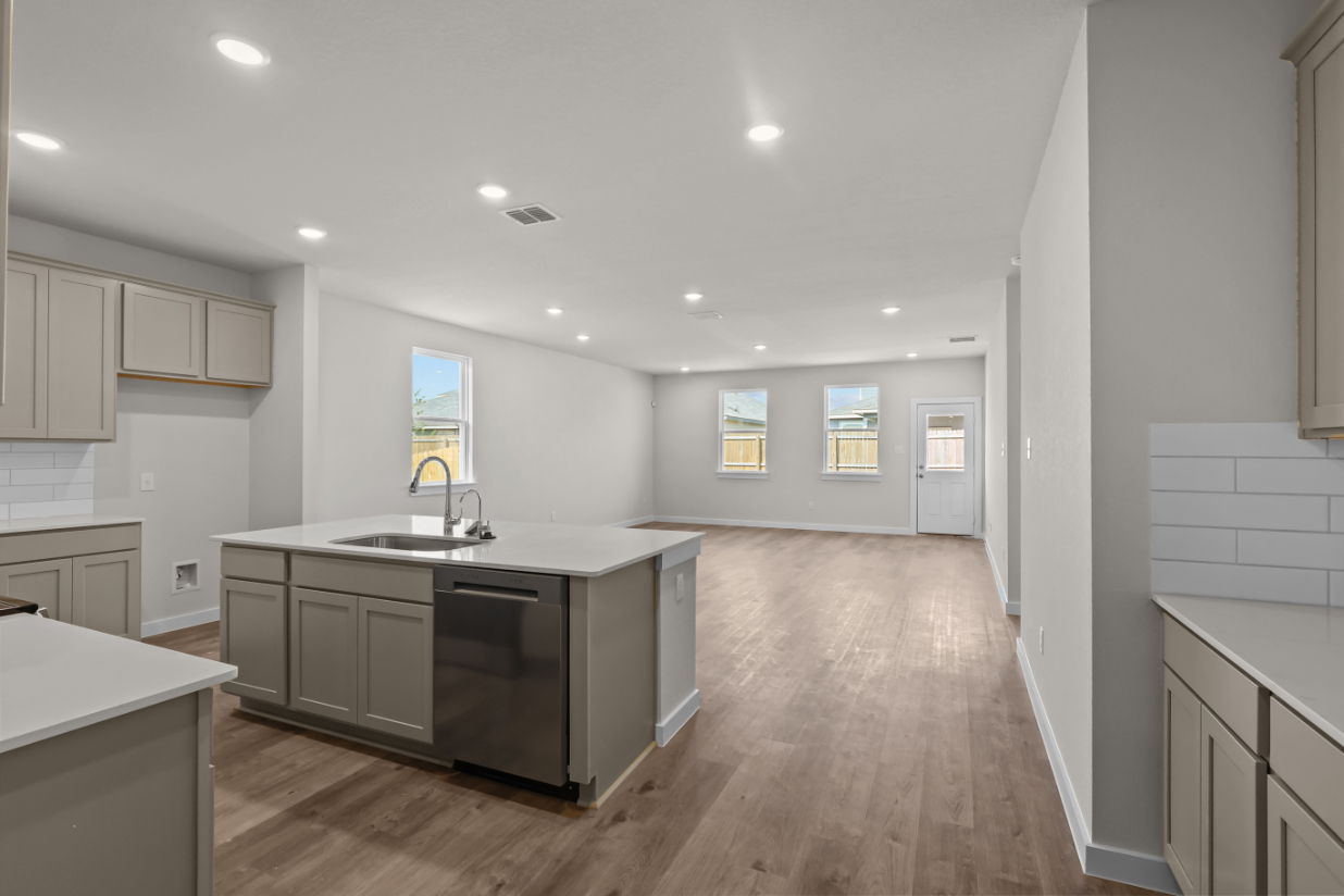 A kitchen with white cabinets.