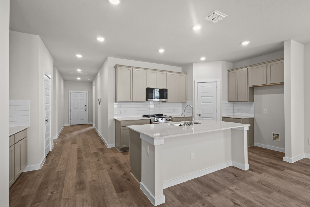 A kitchen with white cabinets.