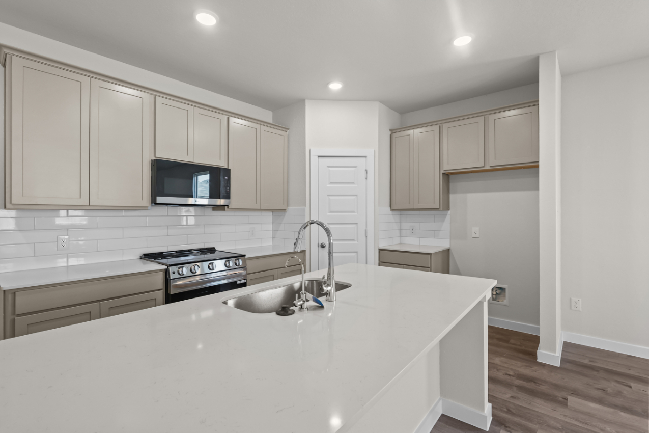 A kitchen with white cabinets.