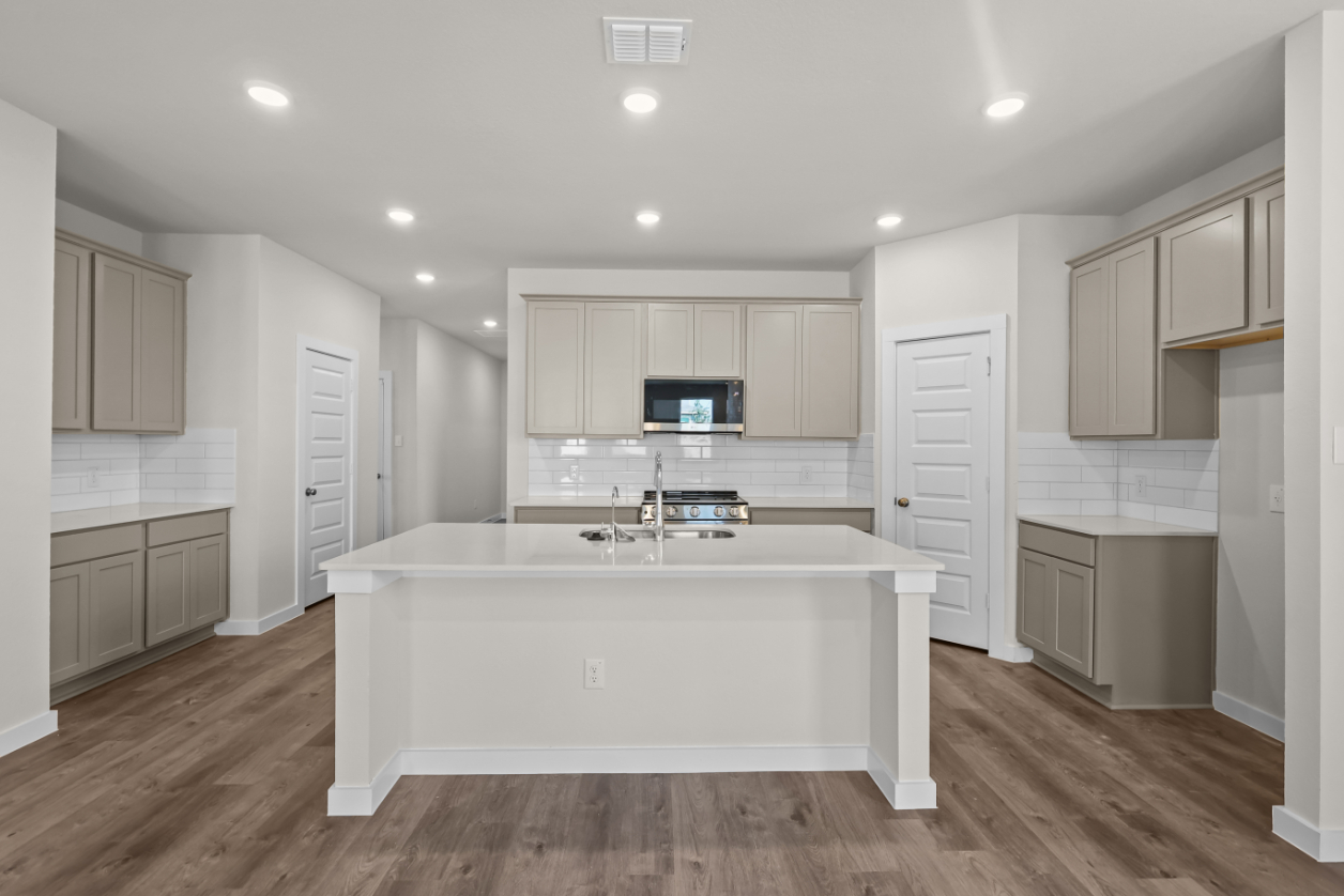 A kitchen with white cabinets.