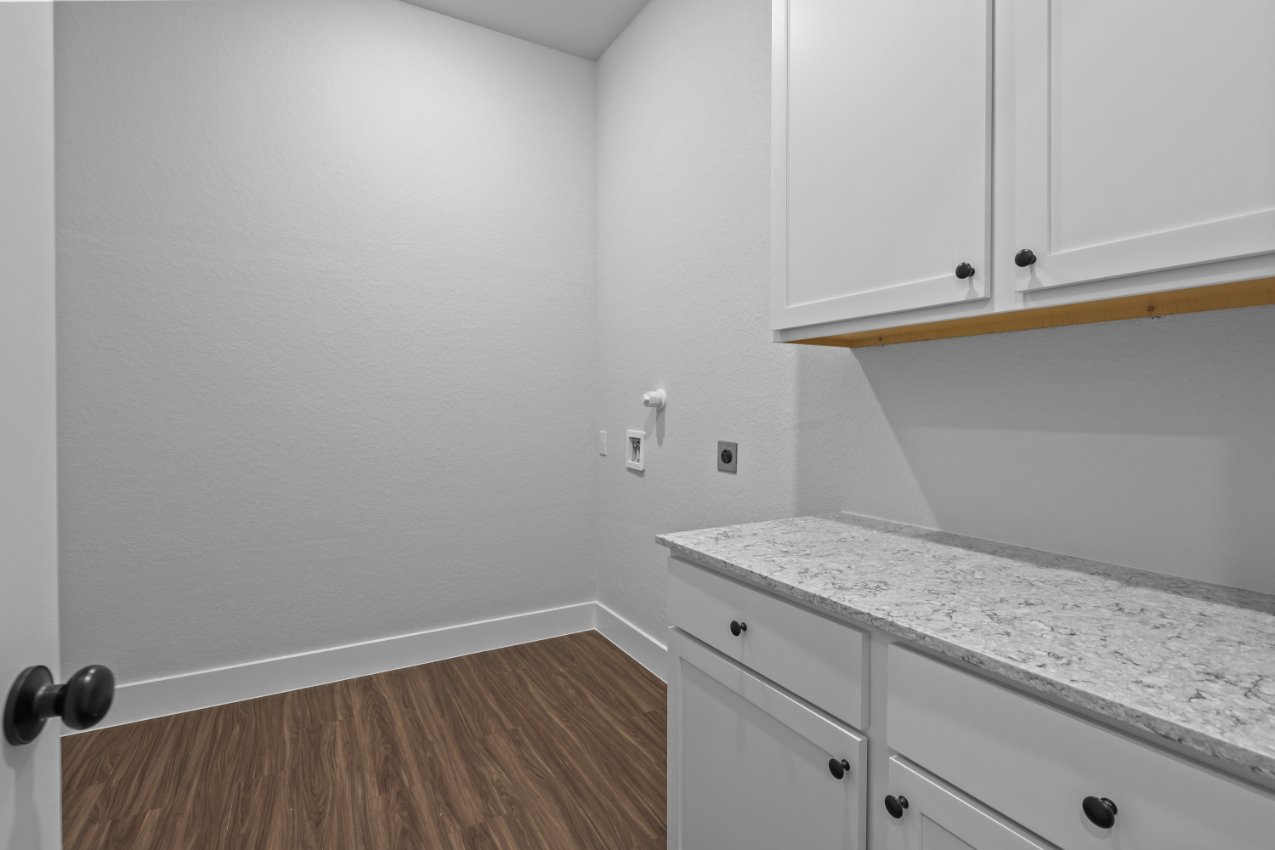 A kitchen with white cabinets.