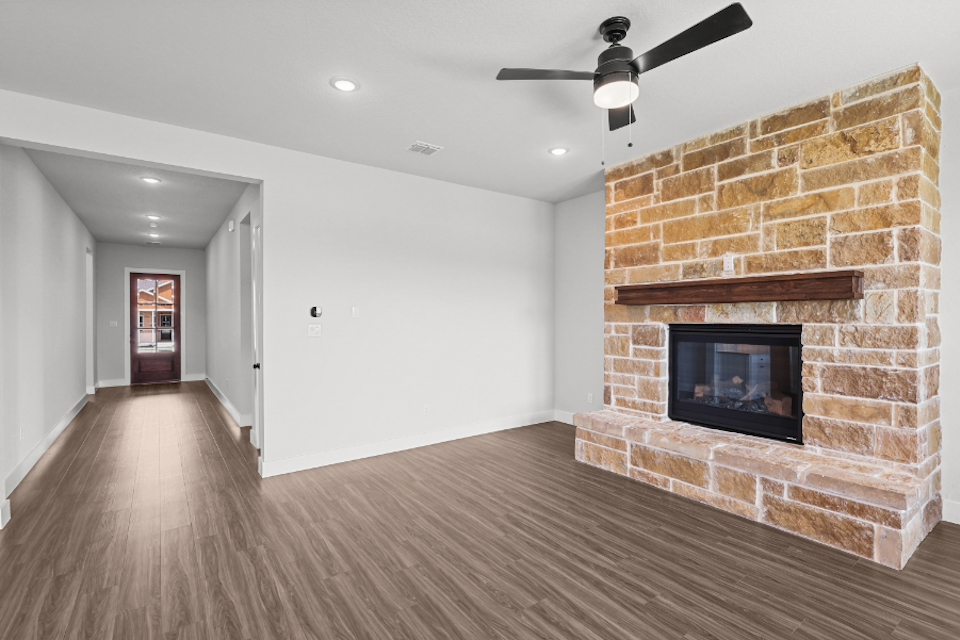 A room with a fireplace and a brick wall.