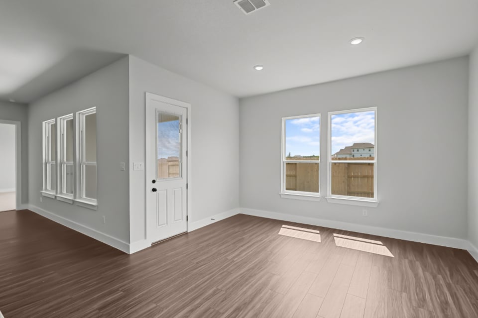 A room with white walls and a wood floor.
