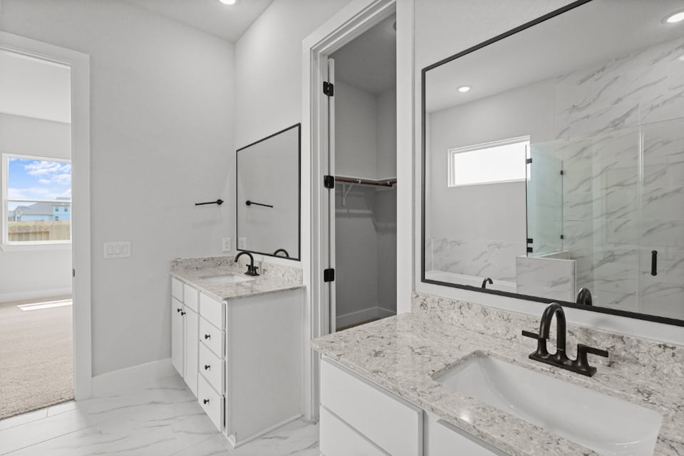 A bathroom with a large mirror.