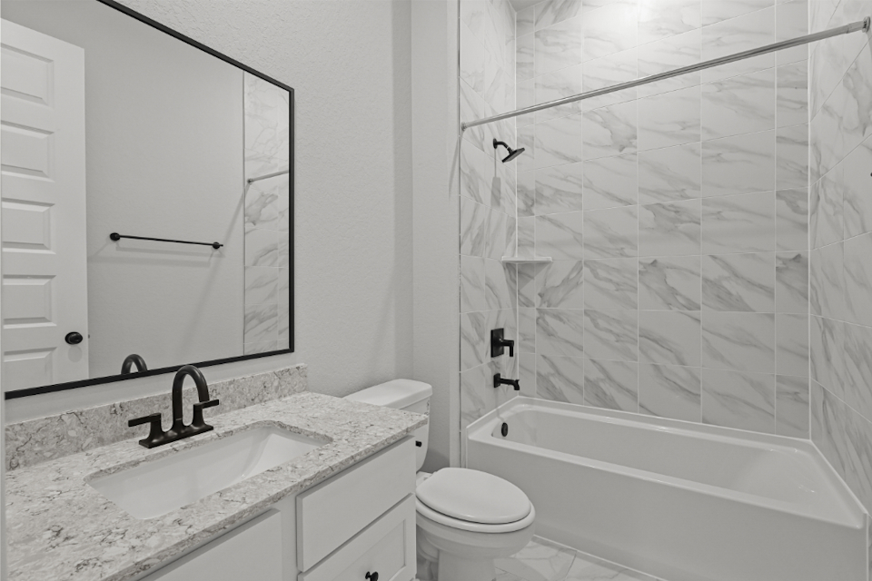 A bathroom with a shower and sink.