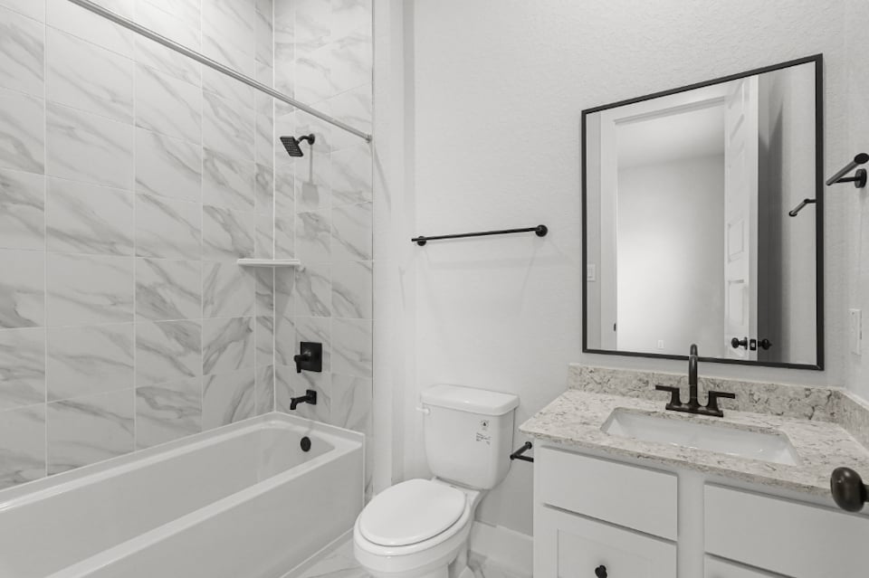 A bathroom with a tub sink and toilet.