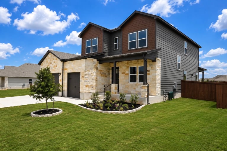 A house with a yard and a fence.