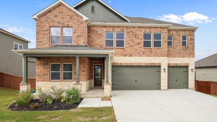A brick house with a garage.