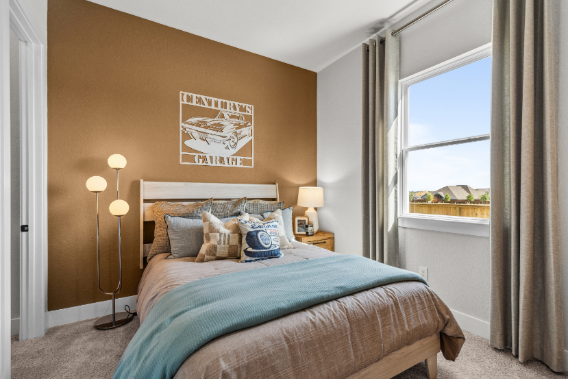 A bedroom with a large window.