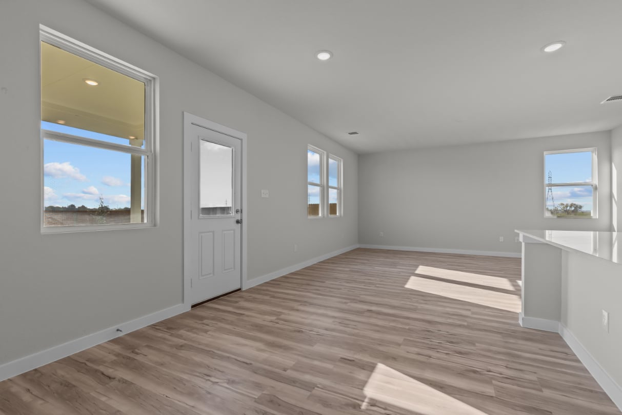 A room with a wood floor and windows.