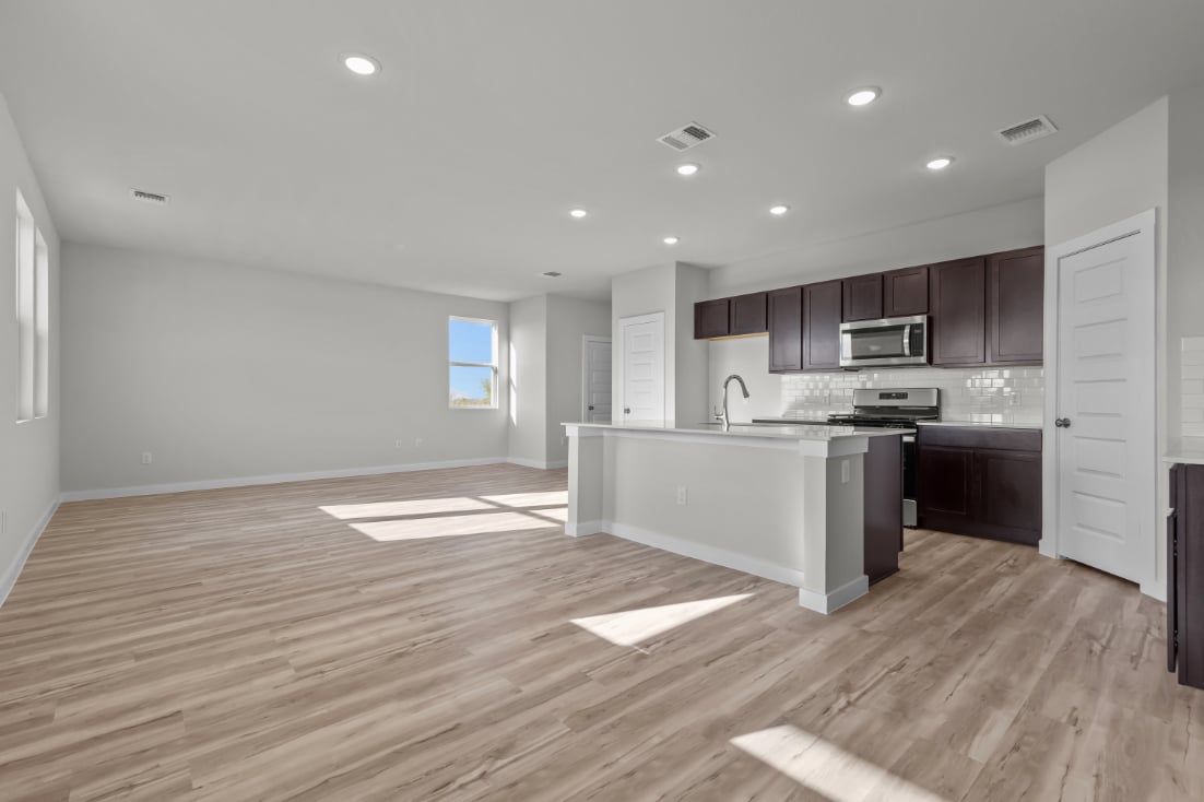 A kitchen with wooden floors.