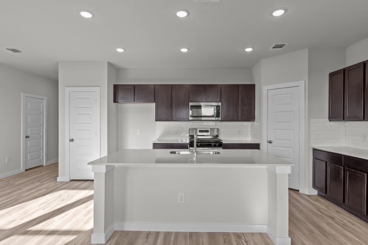 A kitchen with white cabinets.