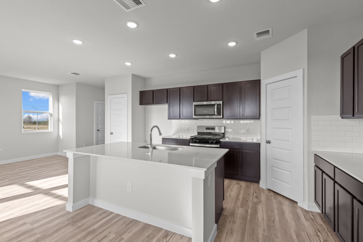 A kitchen with a white counter top.
