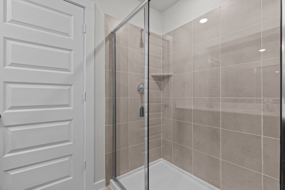 A shower with a glass door.
