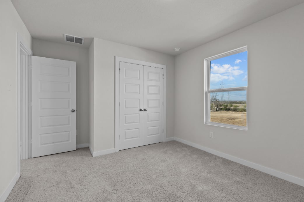 A room with white doors and a window.