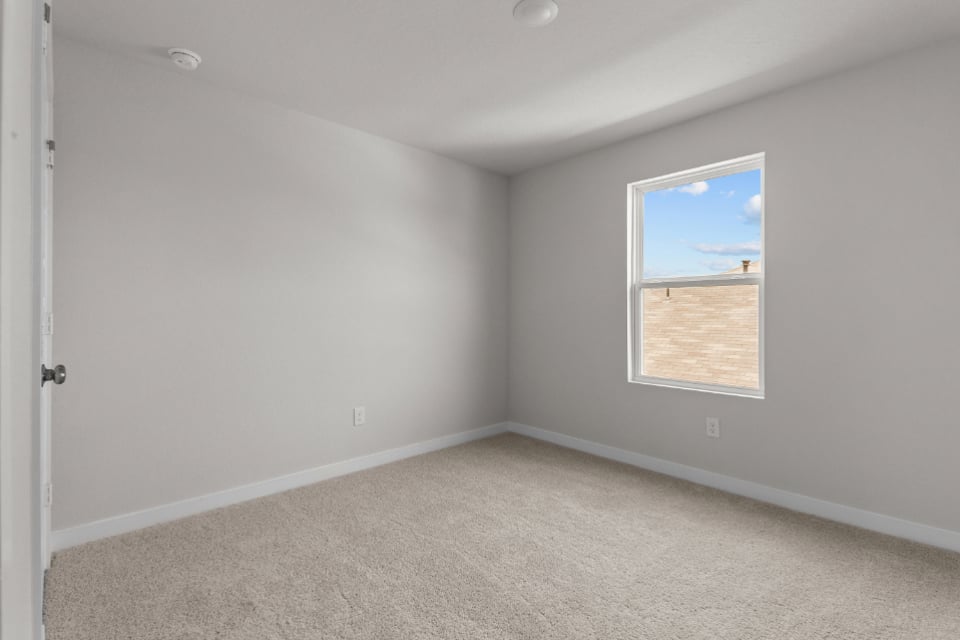 A room with a window and a door.