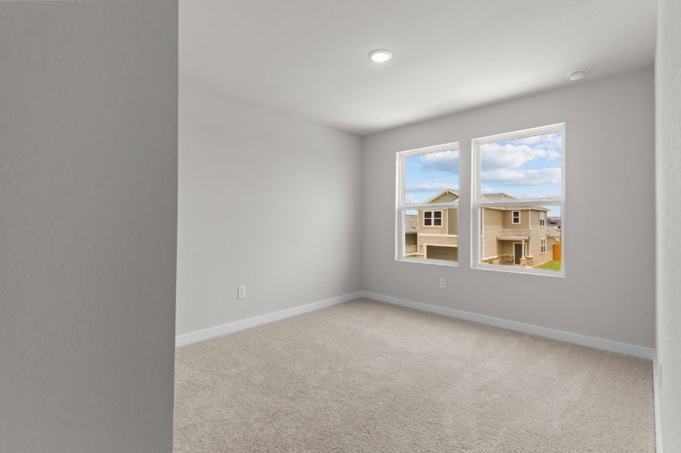 A room with a window and a carpet.