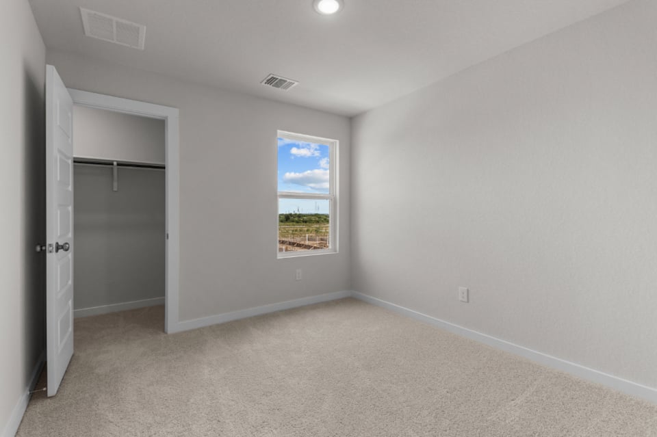 A room with a window and a door.