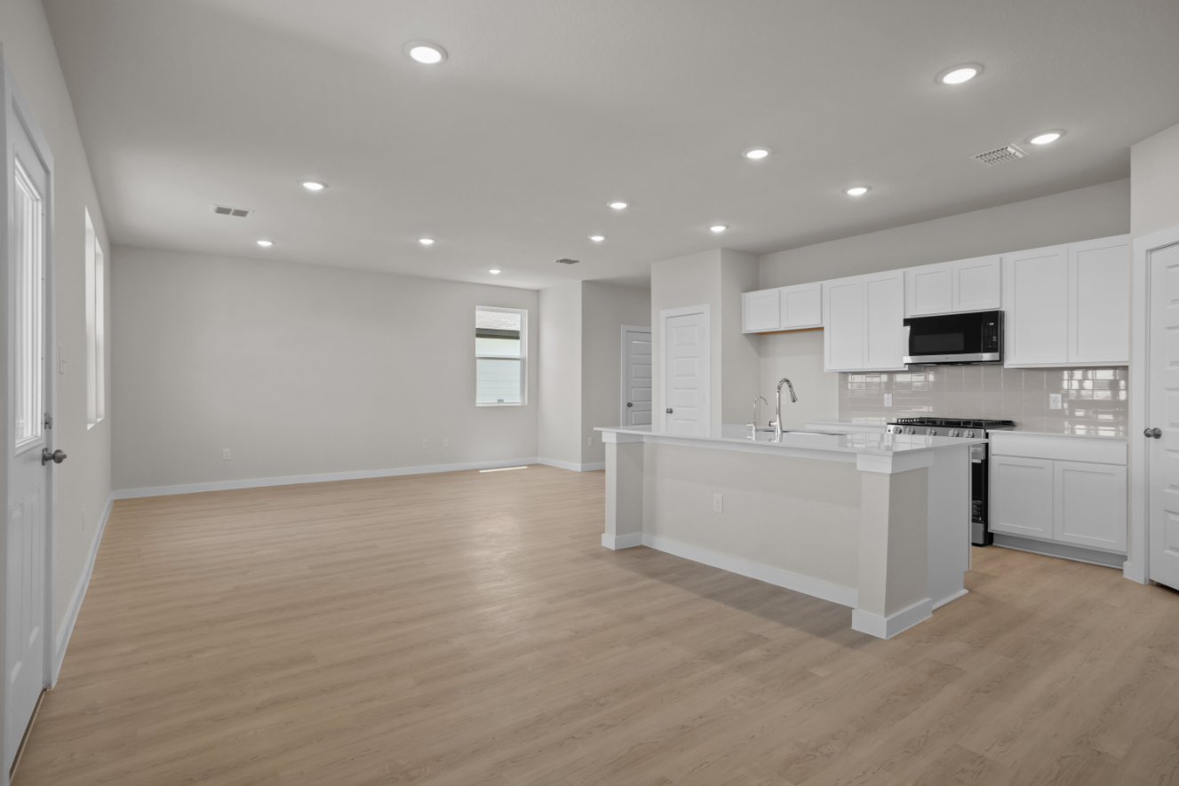 A kitchen with white cabinets.