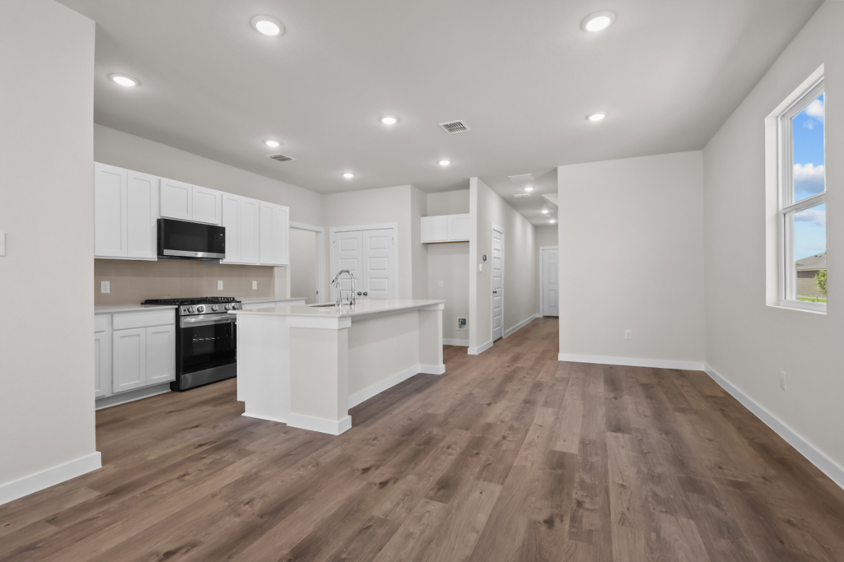 A kitchen with white cabinets.