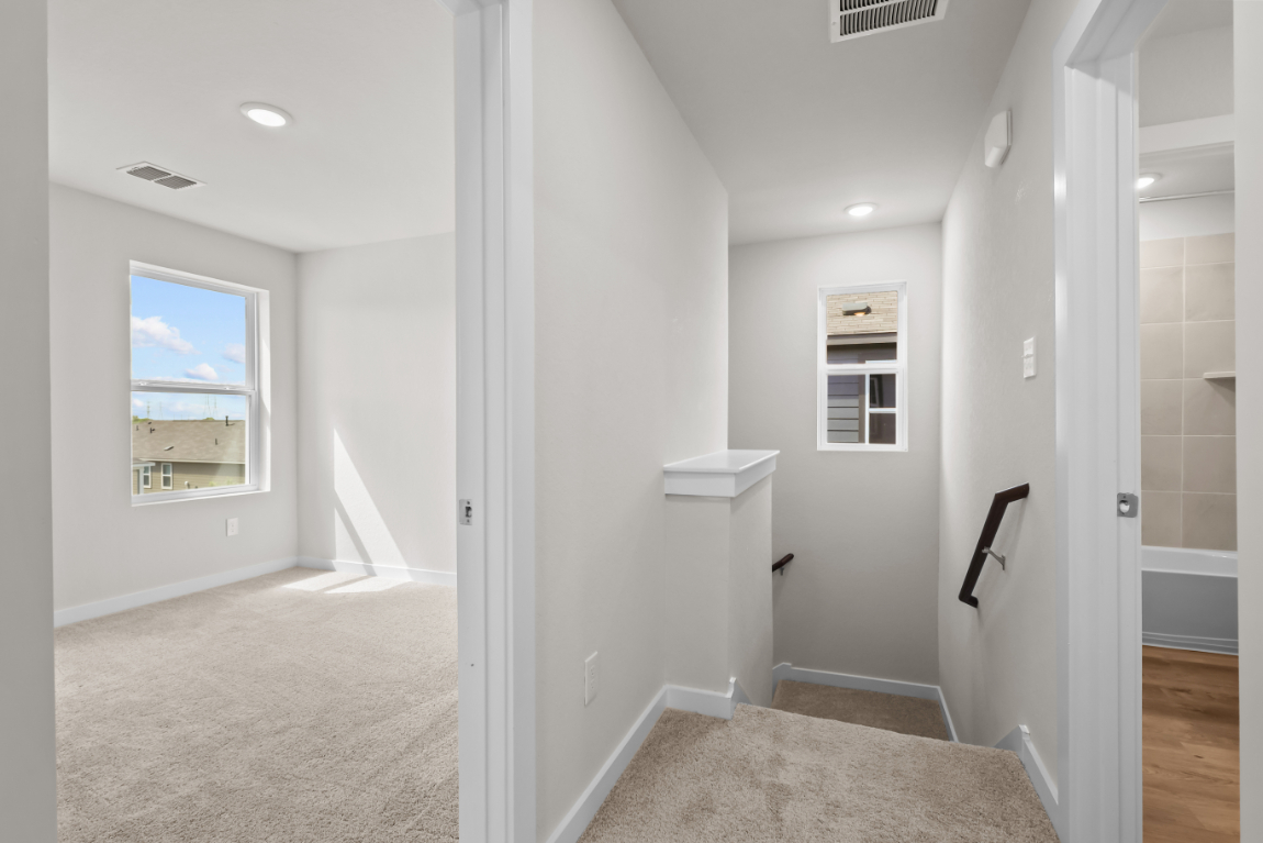 A bathroom with a tub and toilet.