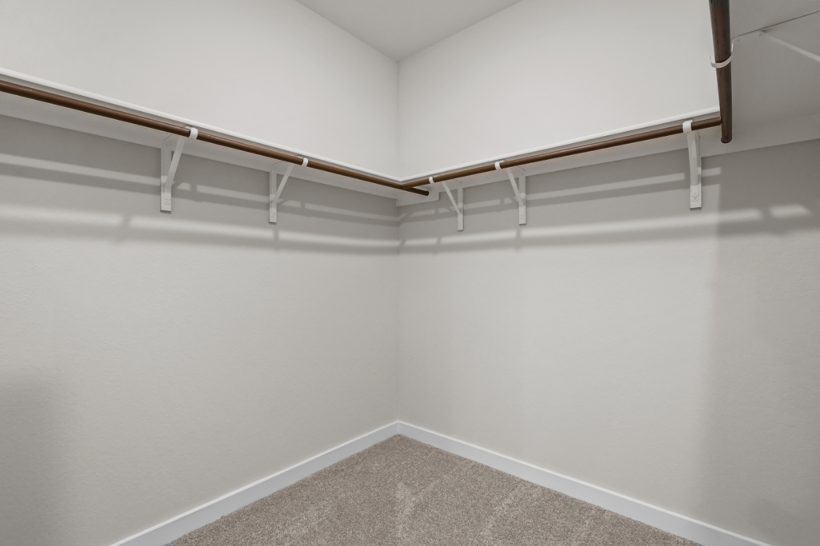 A white staircase with a white wall.
