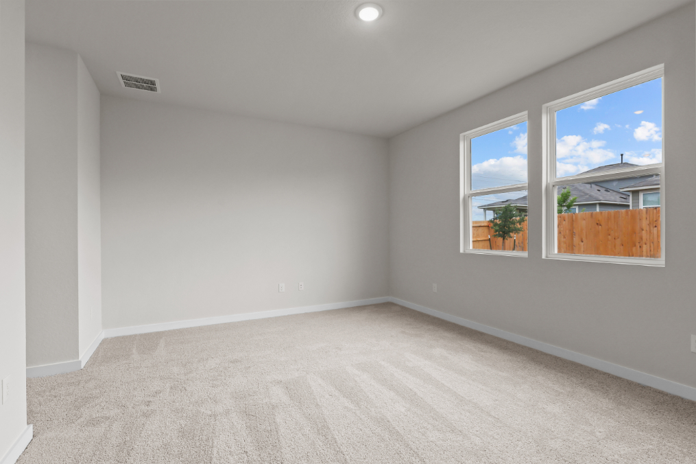 A room with a window and a carpet.