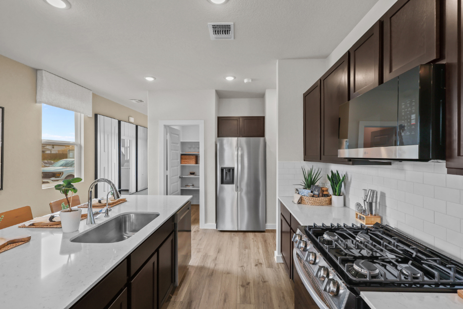 A kitchen with a stove and a refrigerator.