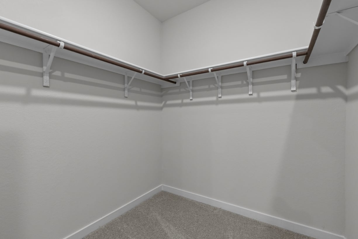 A white wall with a metal railing.