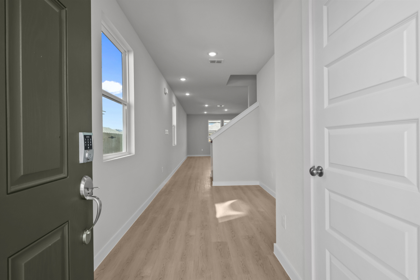 A hallway with white doors.