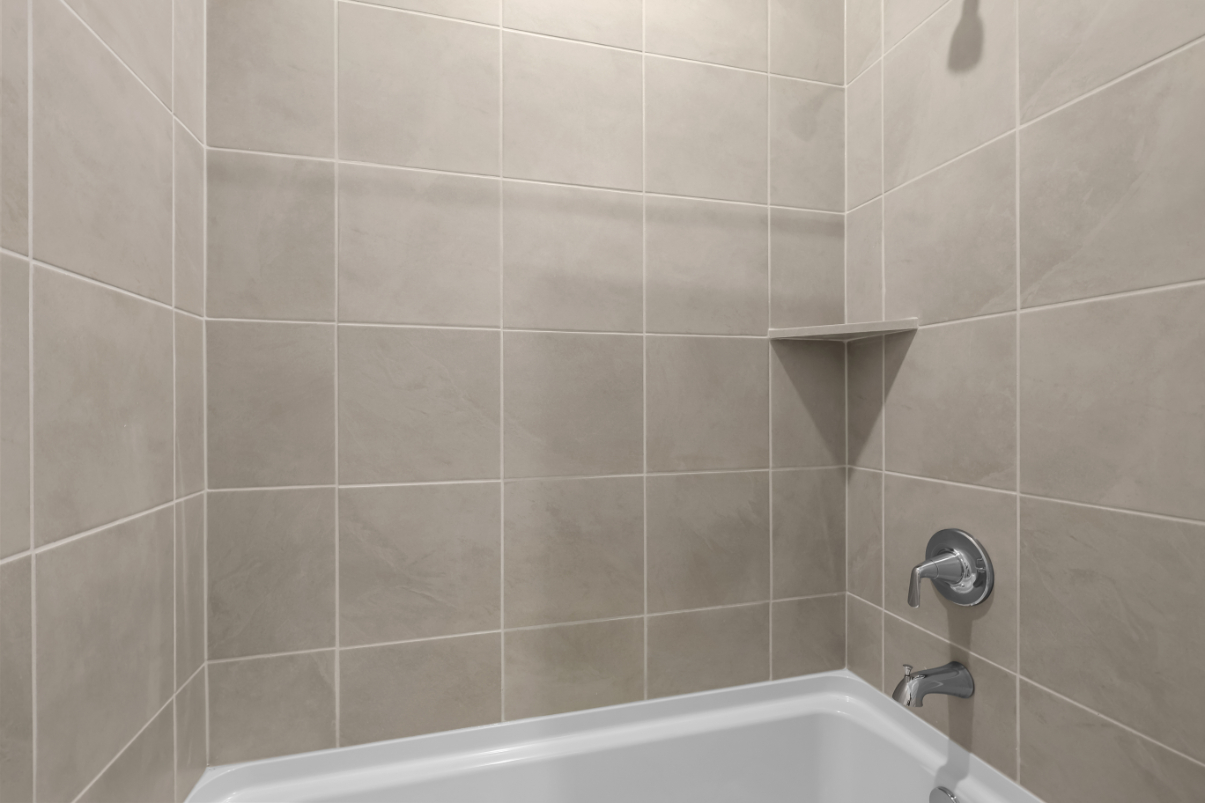 A bathtub in a bathroom.