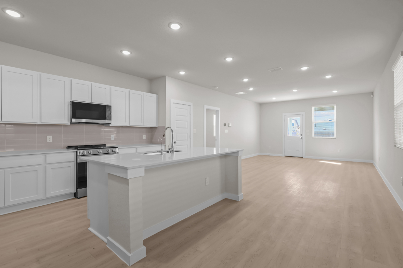 A kitchen with white cabinets.
