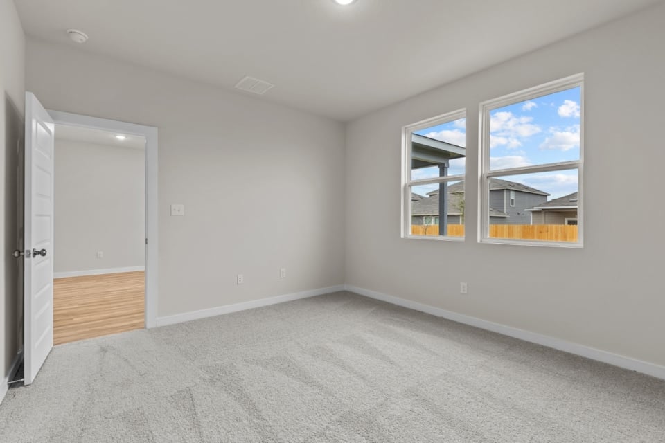 A room with a window and a door.