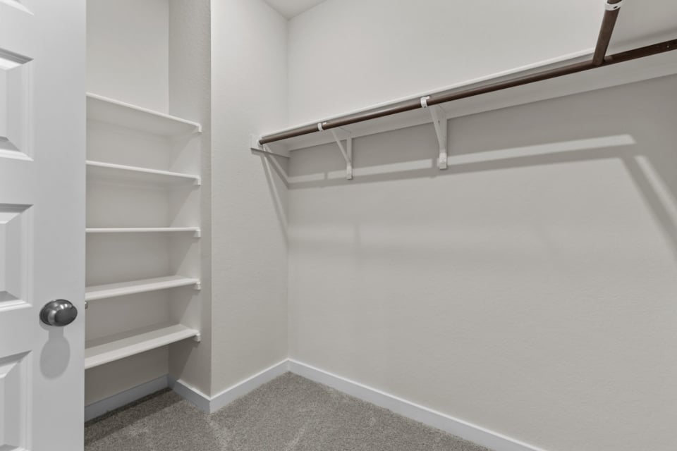 A white wall with a metal bar.