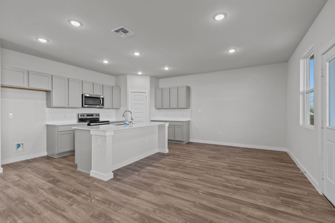A kitchen with white cabinets.