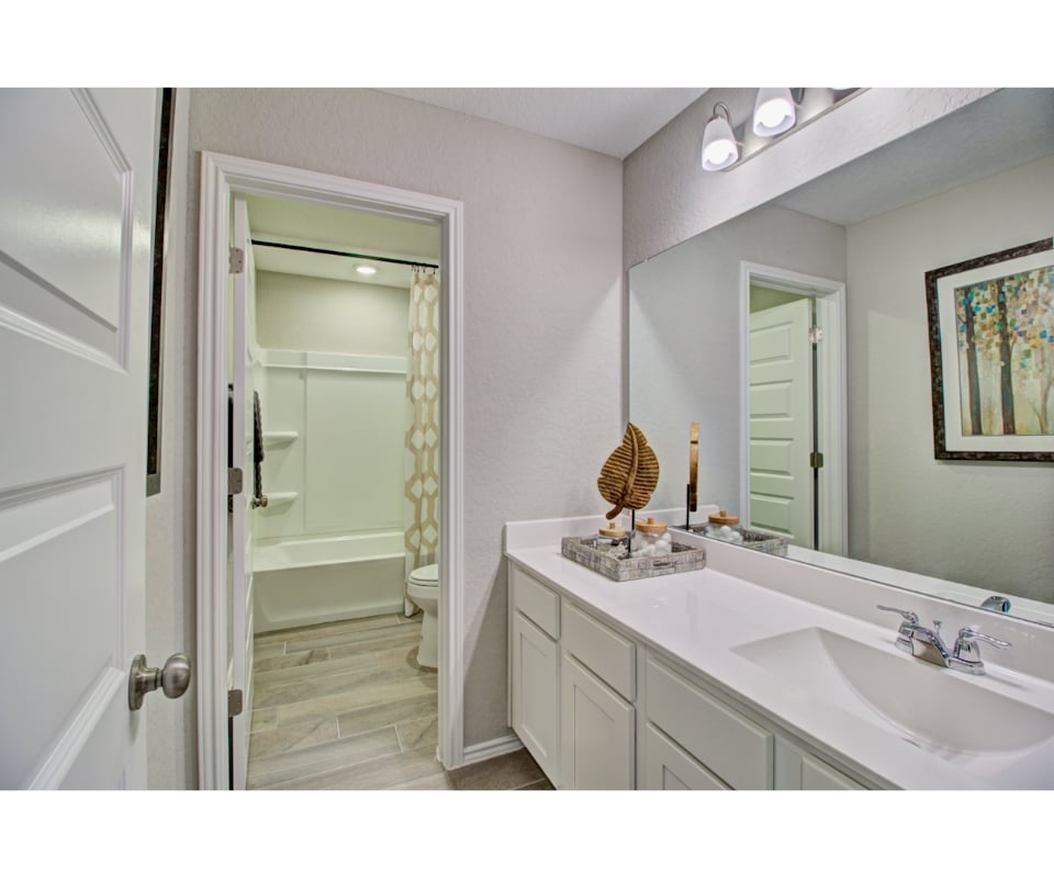 A bathroom with a tub sink and a shower.