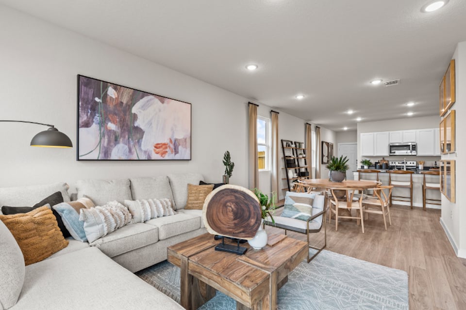 A living room with a wood floor.