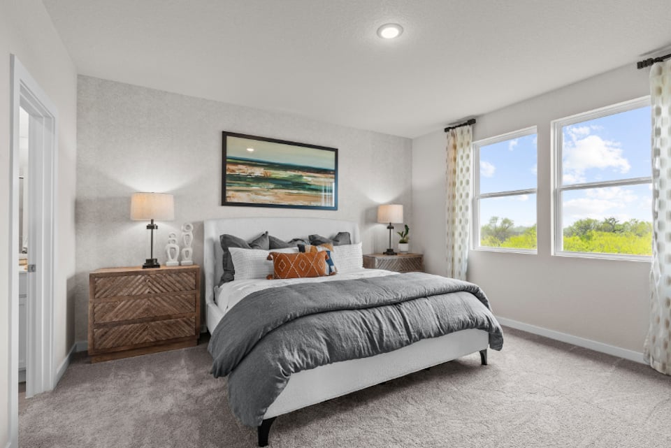A bedroom with a bed and a window.