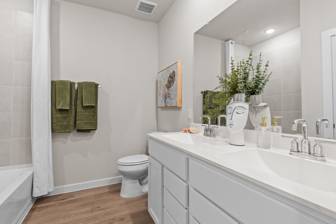 A bathroom with a tub sink and toilet.