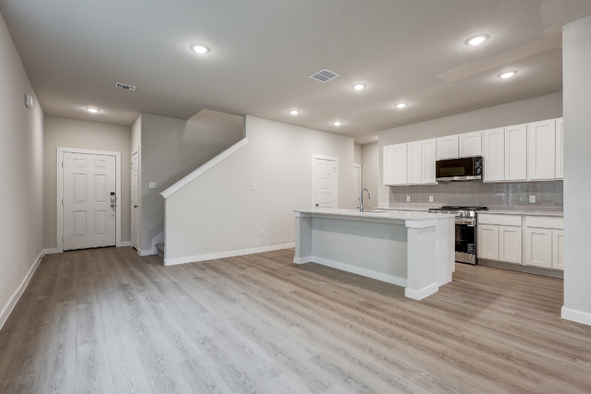 A kitchen with white cabinets.