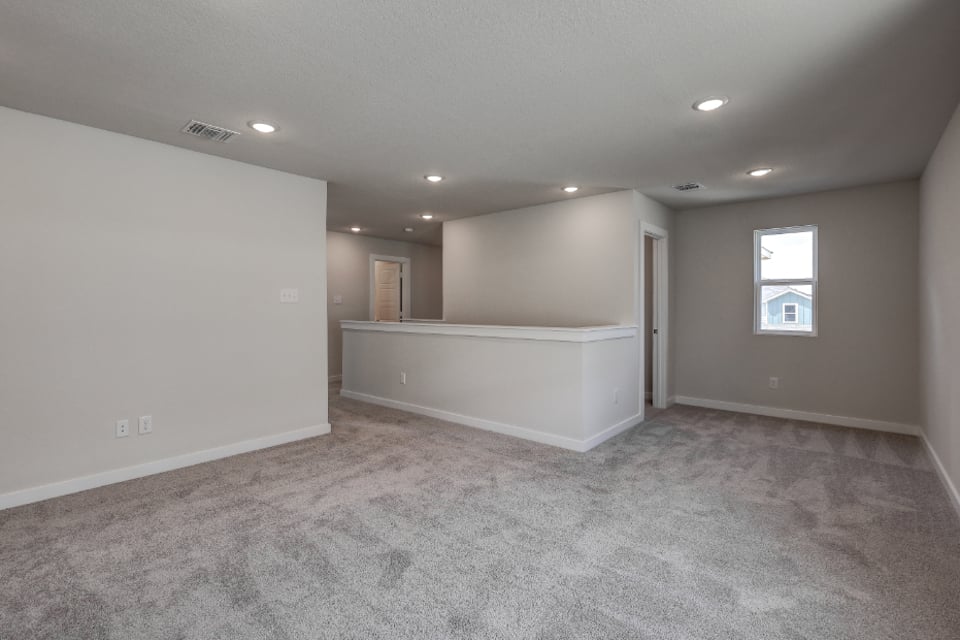 A room with a bed and a window.