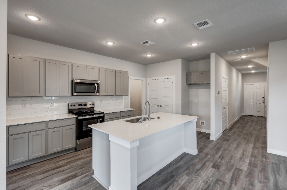 A kitchen with white cabinets.