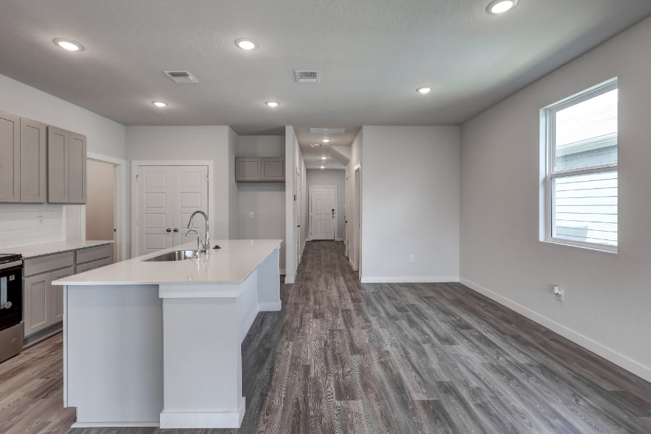 A kitchen with white cabinets.