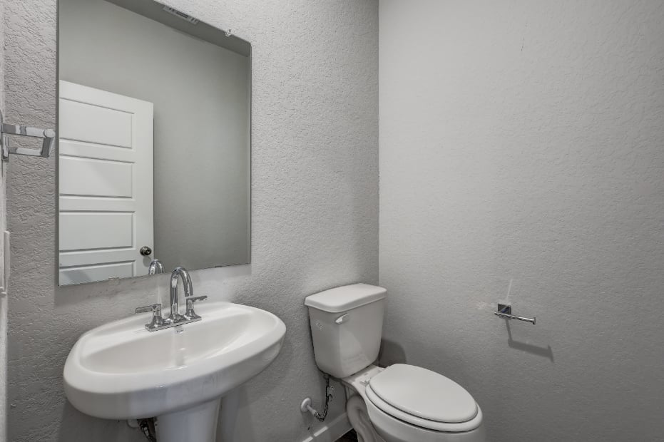 A bathroom with a sink and toilet.
