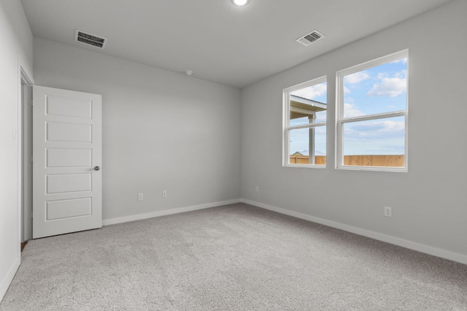 A room with white walls and a window.