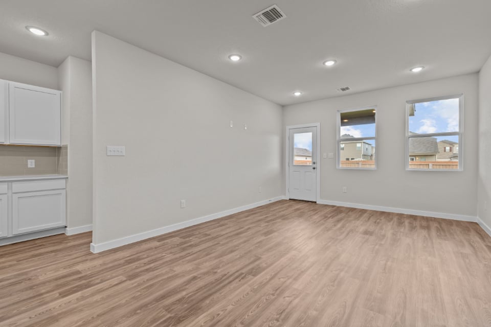 A room with white walls and a wood floor.