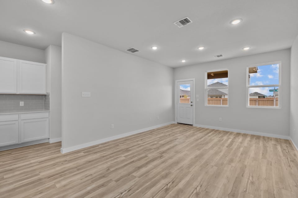A room with white walls and a wood floor.