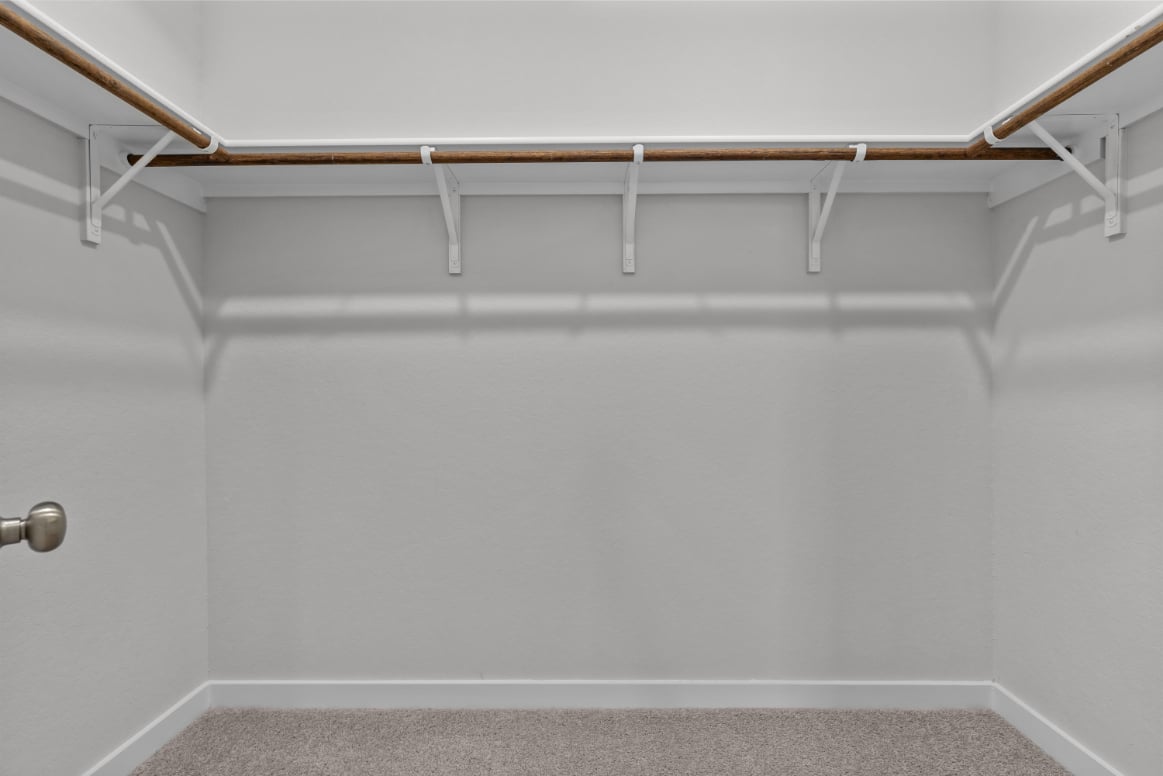 A white wall with a metal railing.