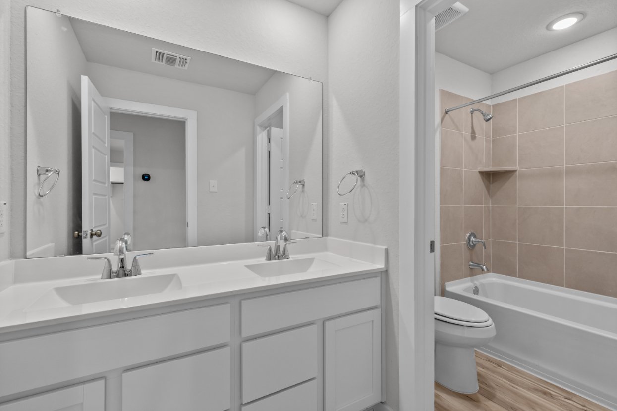 A bathroom with a tub sink and toilet.